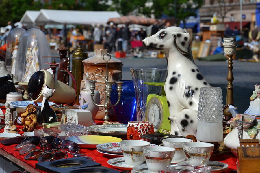 Close up of table top filled with trinkets at a car boot sale