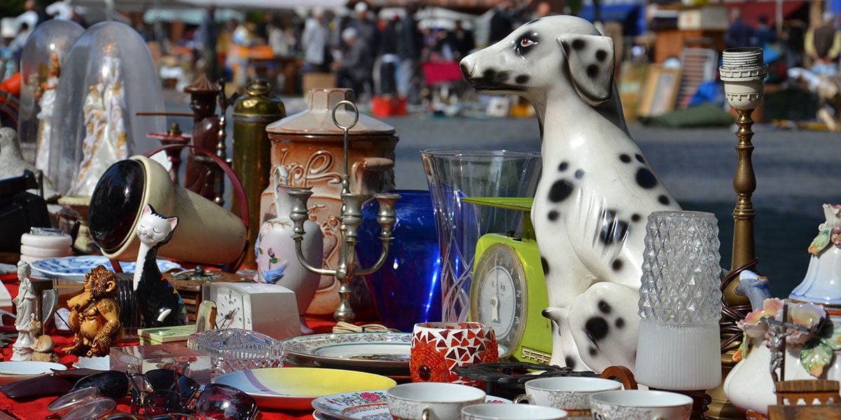 Close up of table top filled with trinkets at a car boot sale