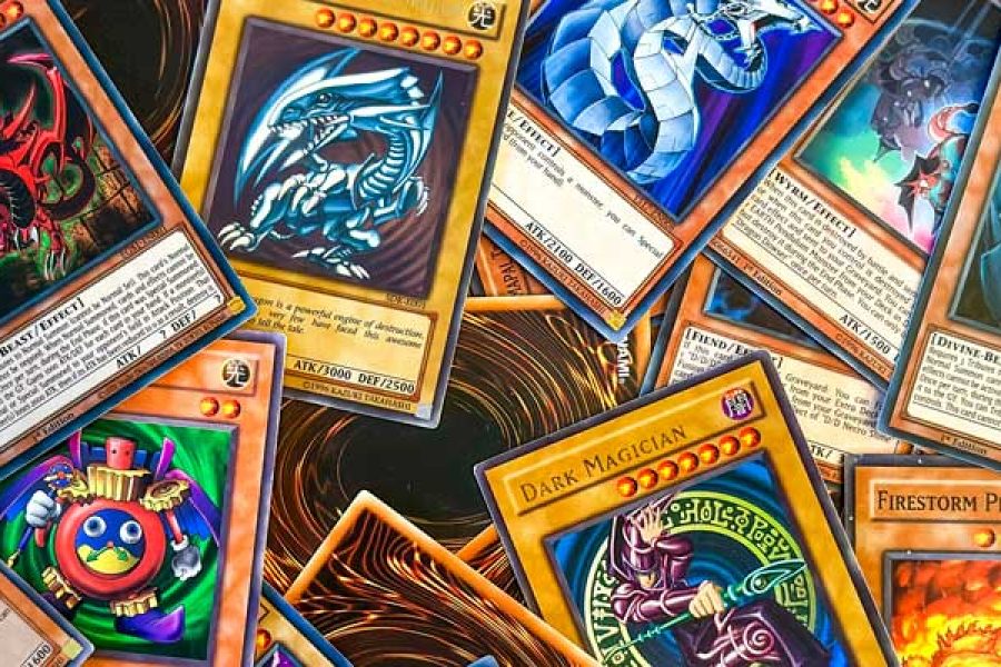 A pile of Yu-Gi-Oh cards, some on their front, others on their back