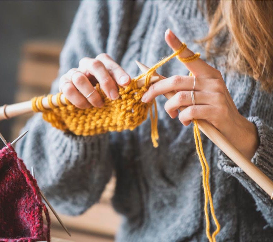 Close up on woman's hands knitting