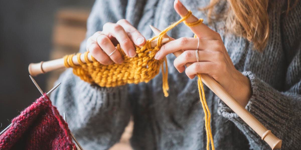 Close up on woman's hands knitting