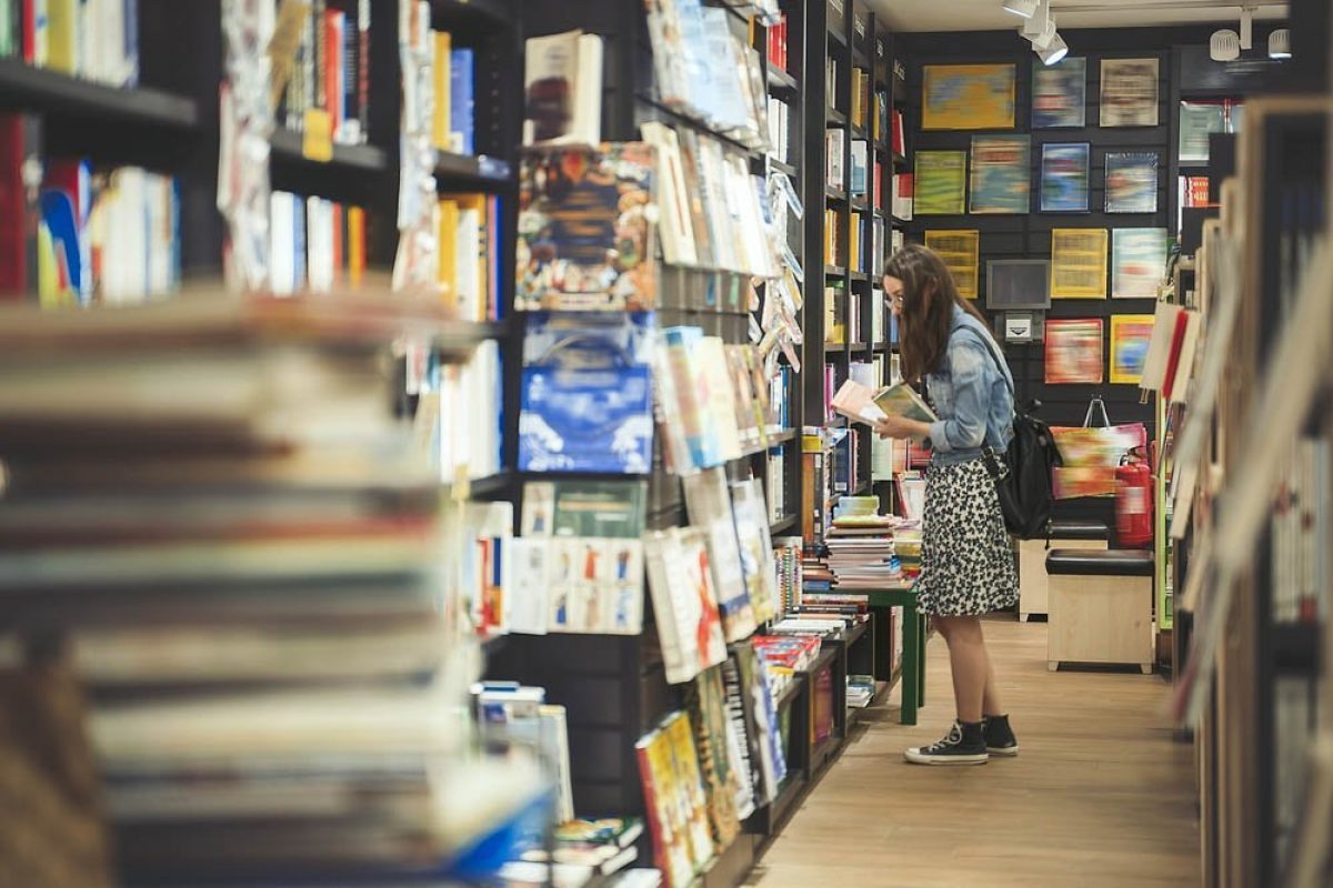 Female student searching for books in the campus library