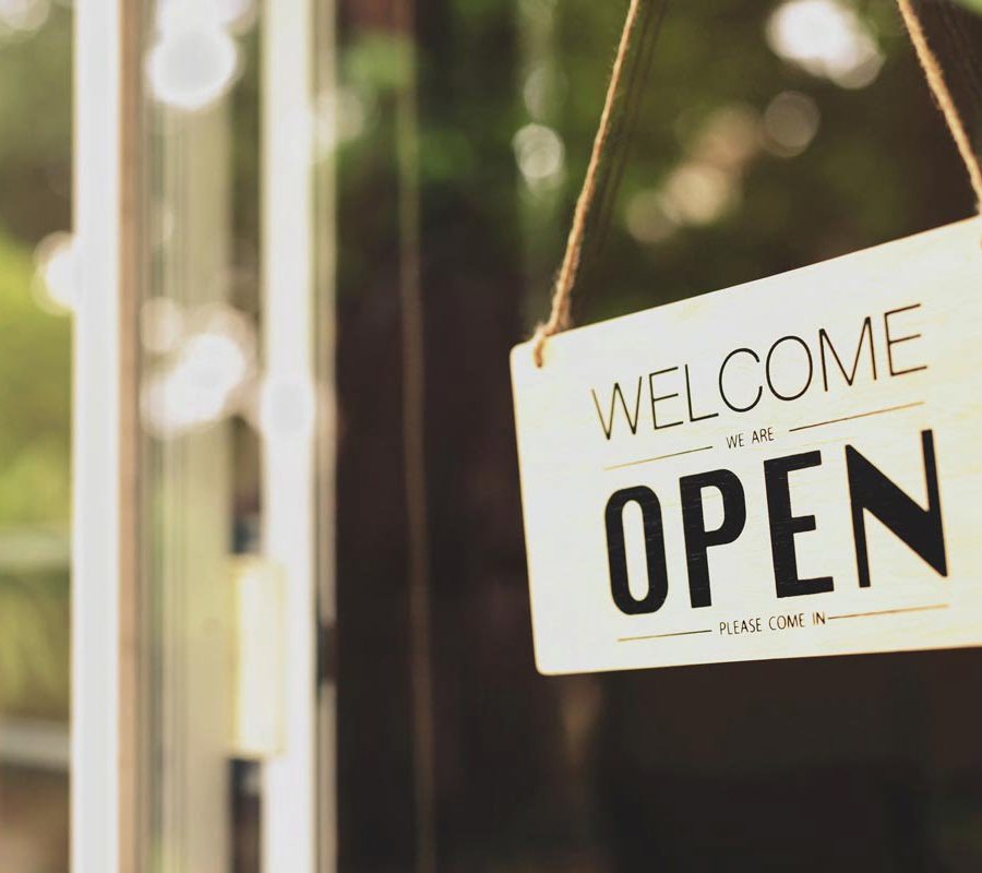 A business sign that says "u2018Open"u2019 on cafe or restaurant hang on door at entrance. Vintage color tone style.