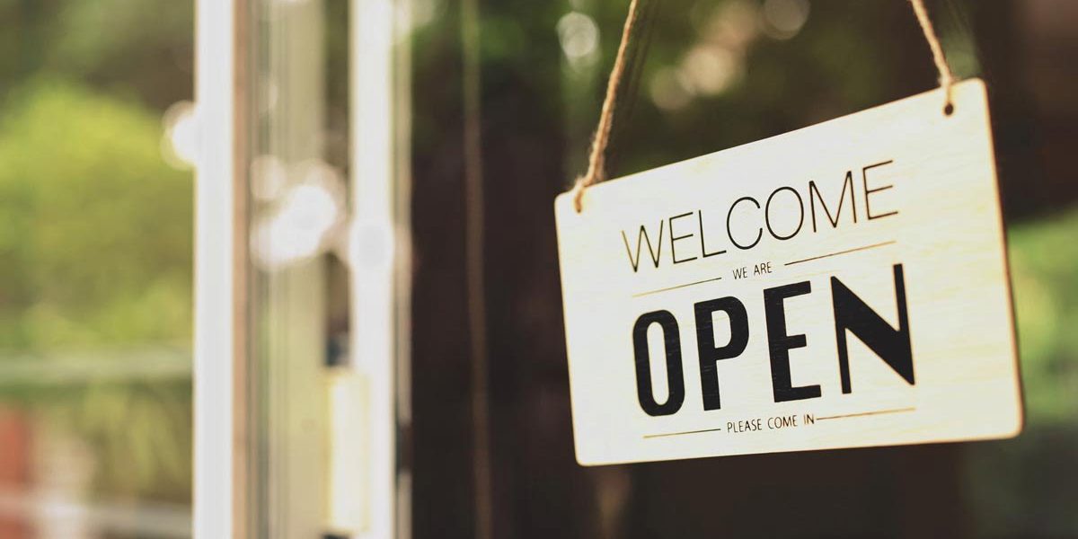 A business sign that says "u2018Open"u2019 on cafe or restaurant hang on door at entrance. Vintage color tone style.