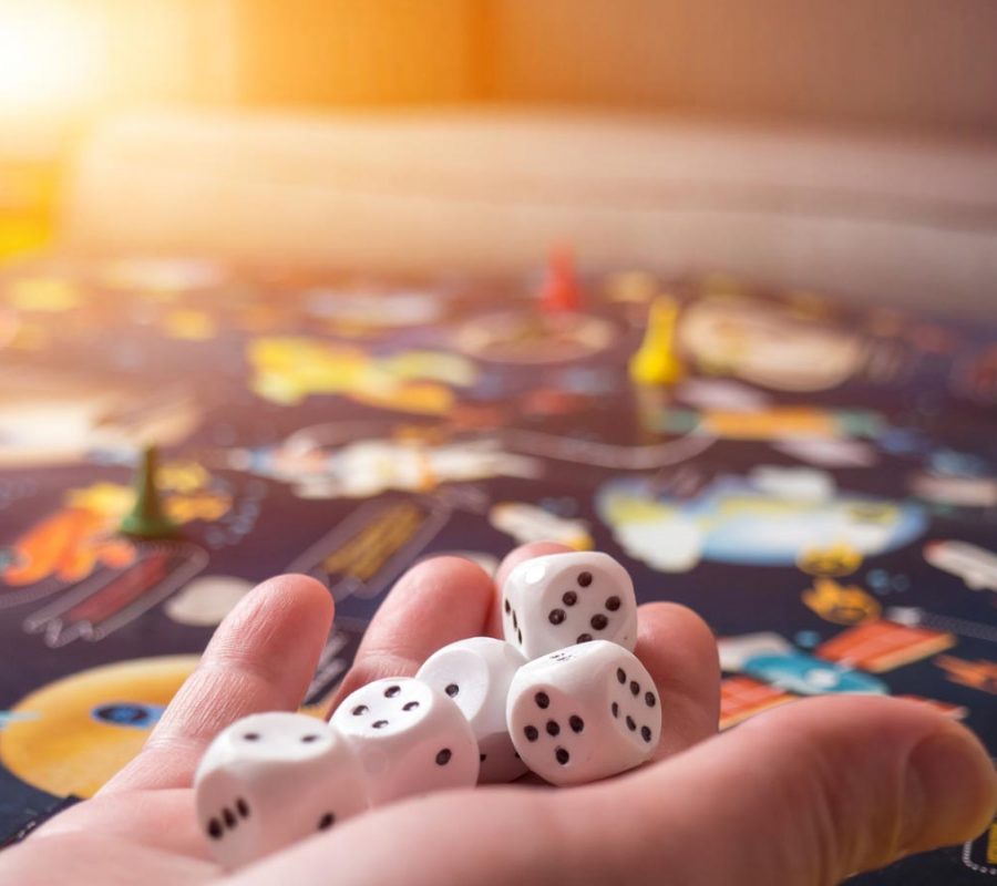 board games concept. Dice, chips and cards on the background of the playing field copy space