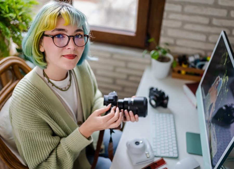 Millennial photographer working on her photos at home office
