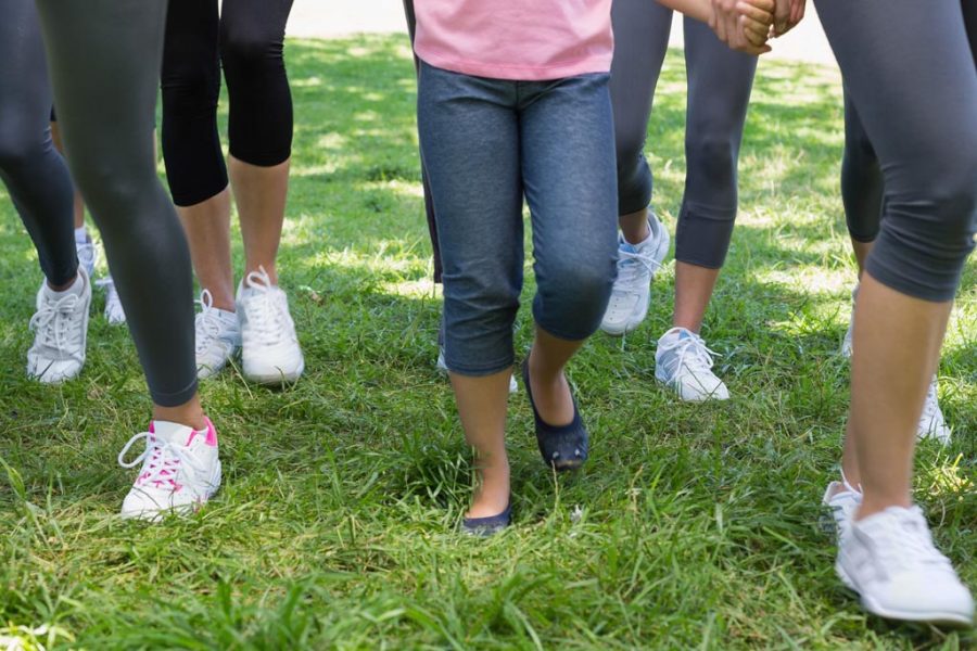 Low section of women and girl participating in breast cancer campaign in park