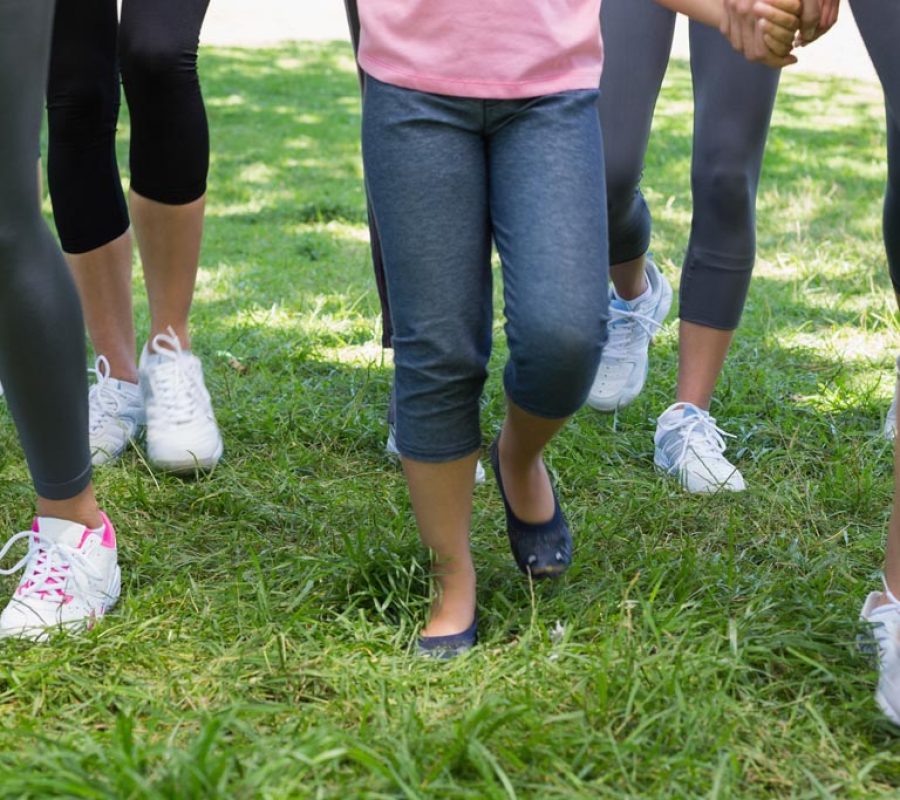 Low section of women and girl participating in breast cancer campaign in park
