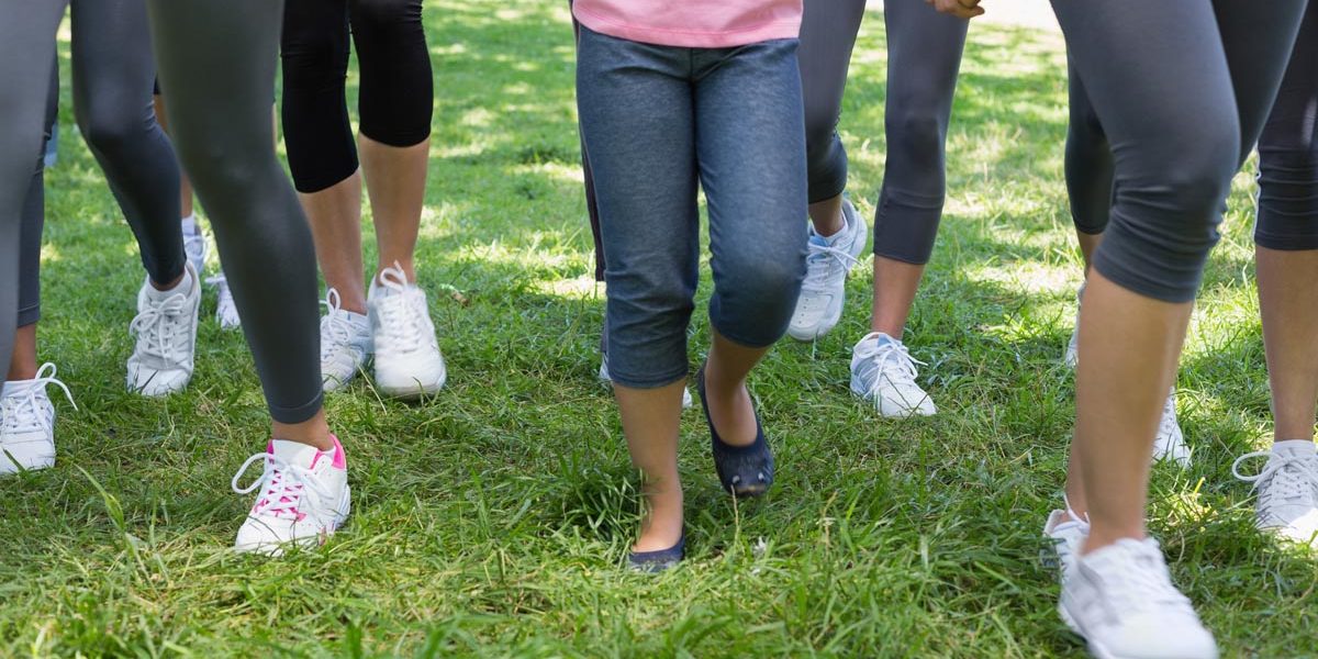 Low section of women and girl participating in breast cancer campaign in park