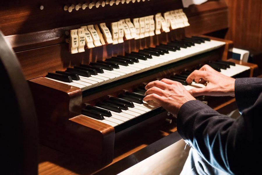 Germany, Europe: Detail of a man playing a organ.