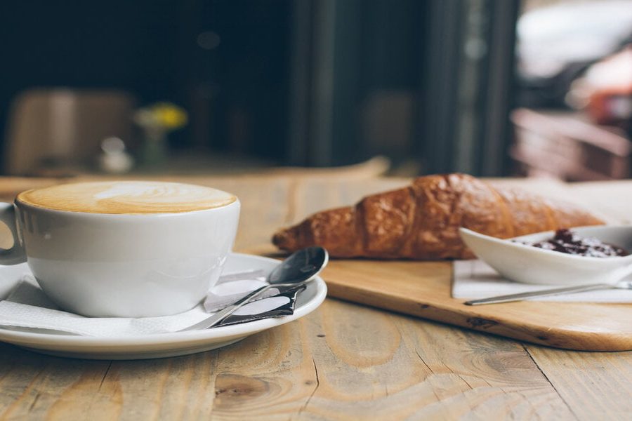 Coffee, Croissant and jam on a wooden table
