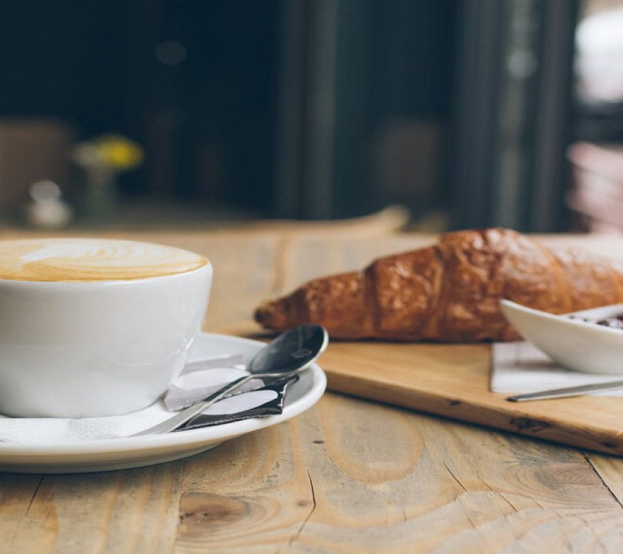 Coffee, Croissant and jam on a wooden table